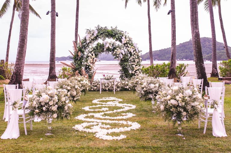 Wedding ceremony arch decorated with flowers on lawn with beach background at Ujiji Waterfront Kigoma Lake Tanganyika