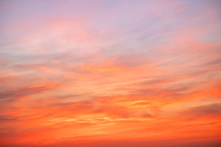 Beautiful sunset sky with dramatic golden orange clouds and sunlight — Wedding Lighting Planner Tanzania golden hour photography