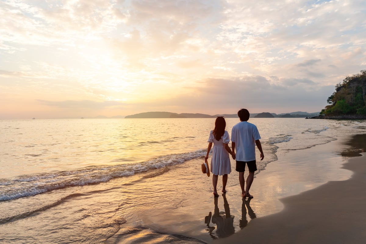 Honeymoon couple watching a tranquil sunset on a Tanzania beach