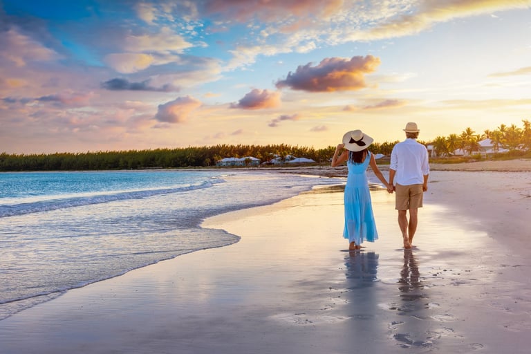 Couple walking on a tropical paradise beach in Zanzibar at sunset