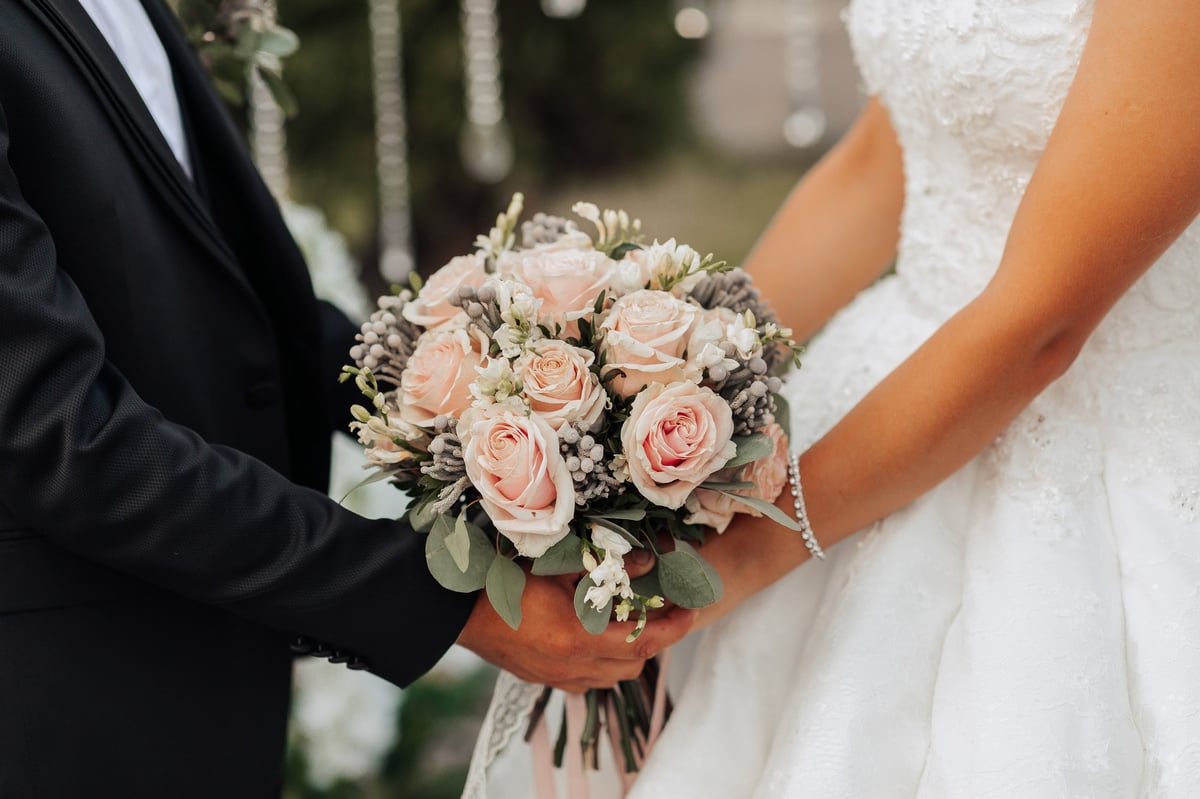 Bride and groom holding wedding bouquet at their Dodoma ceremony