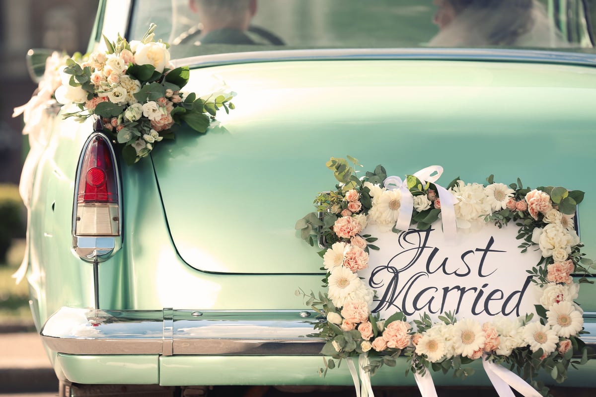 Charming vintage car adorned with wedding decor and floral arrangements at Keys Hotel Mbokomu Moshi wedding celebration