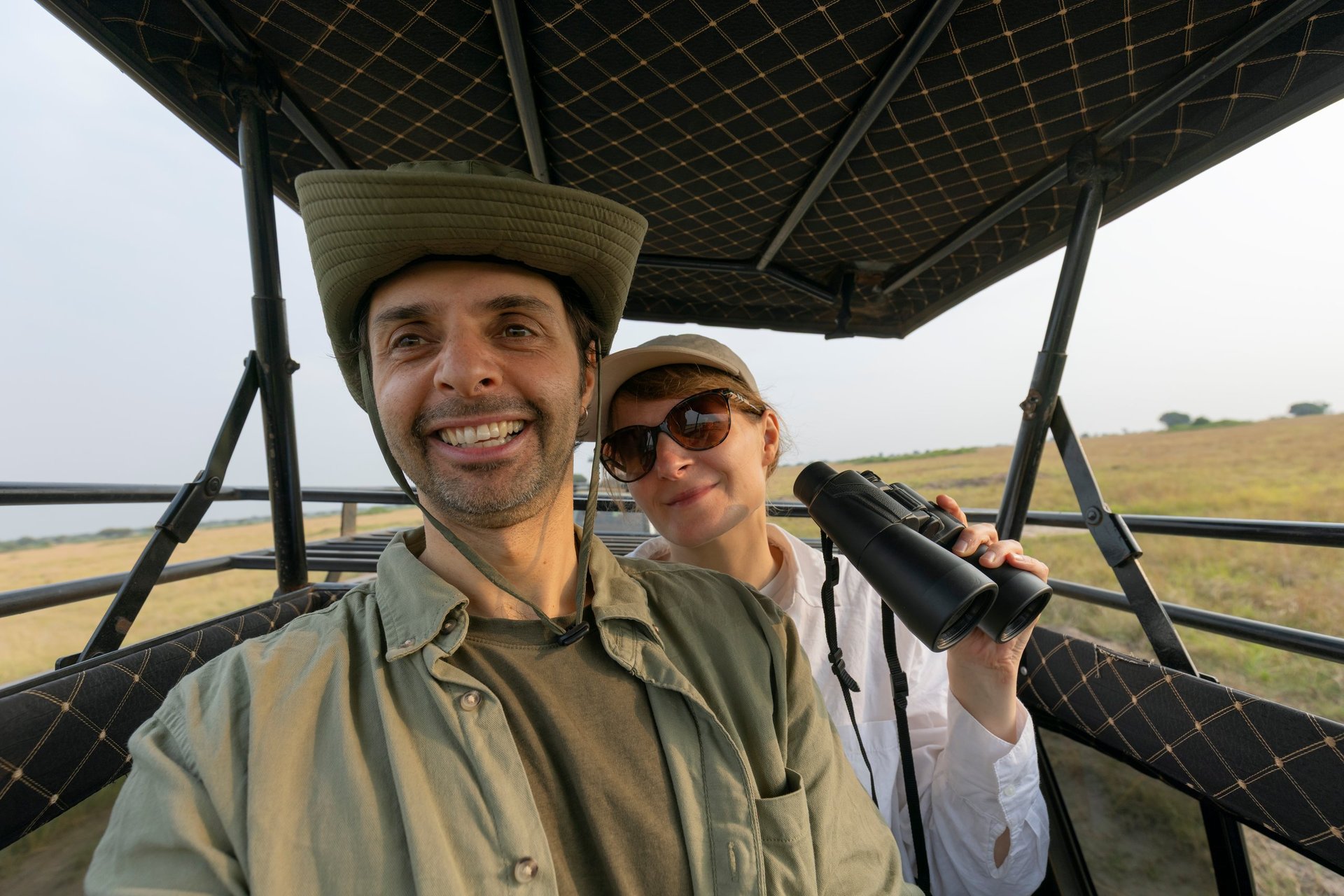 Couple in an open safari vehicle on an African park adventure in Tanzania