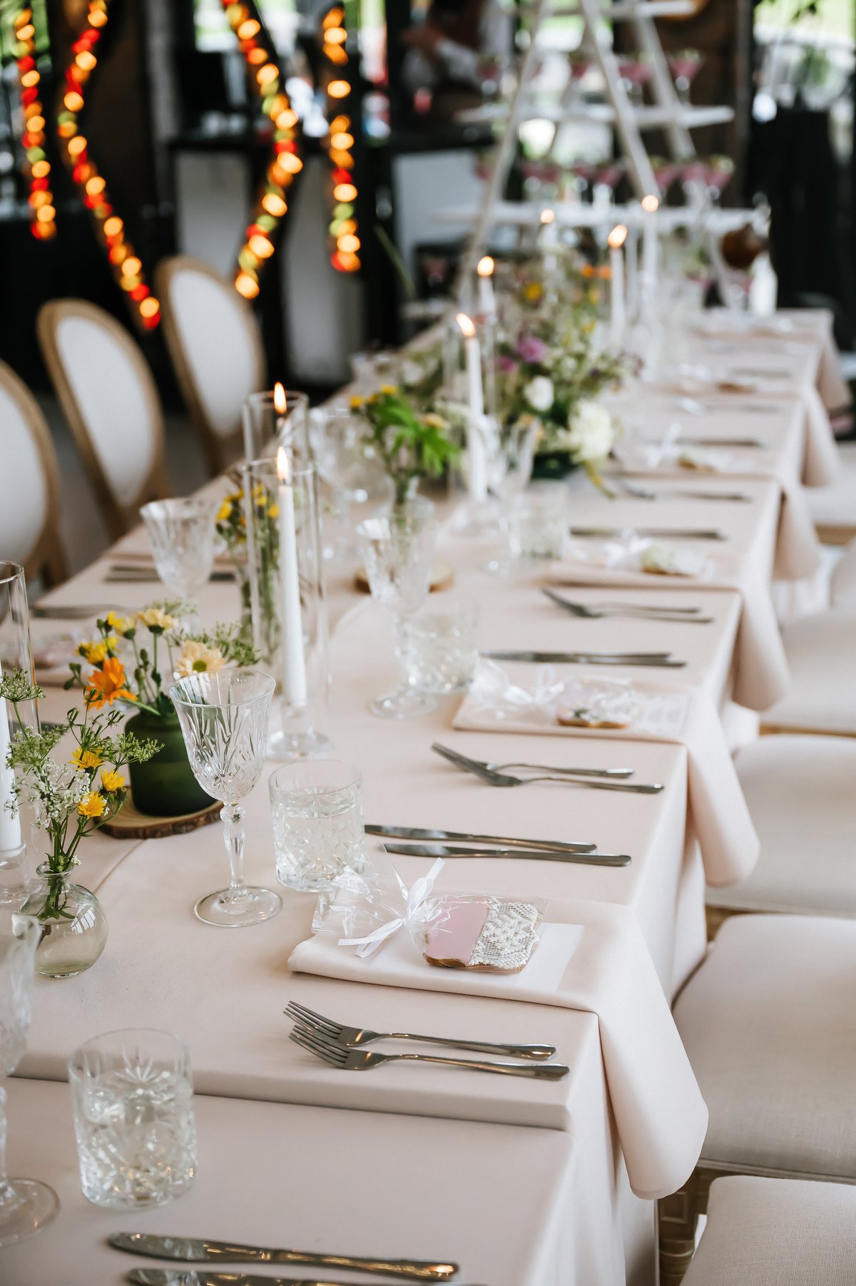 Beautifully styled wedding reception at St. Gaspar Hotel Dodoma with candles, floral arrangements and elegant glassware