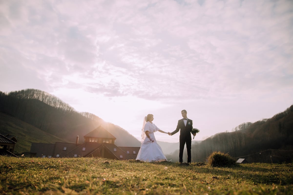 Bride and groom in field with Kilimanjaro mountain views at Moshi wedding