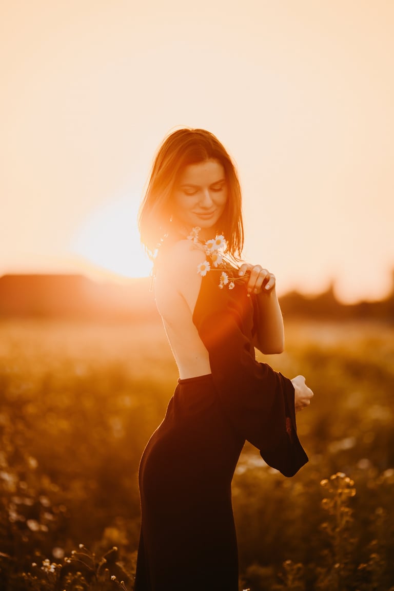 Graceful woman holding vibrant flowers at sunset in Kigoma Tanzania wedding portrait Lake Tanganyika