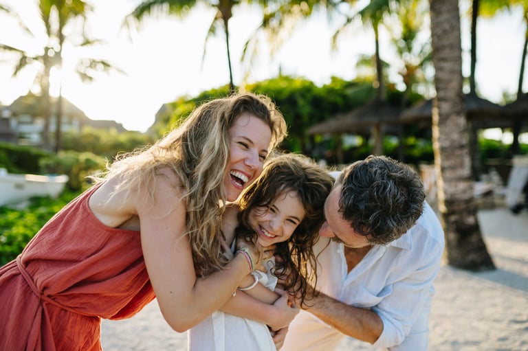 Parents and daughter spending summer vacation at a tropical beach resort