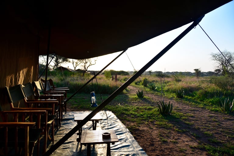 Luxury safari tent glowing at sunset in the Serengeti, Tanzania