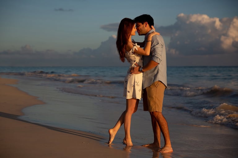 Zanzibar destination wedding videographer capturing couple kissing at sunset on beach with cinematic film quality