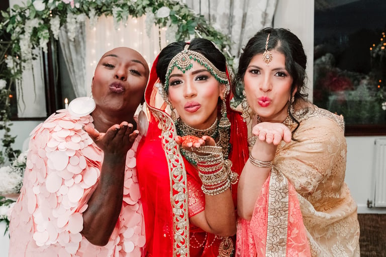 Tanzanian wedding bridesmaids in colorful traditional dresses and gold jewelry at a luxury wedding celebration in Tanzania