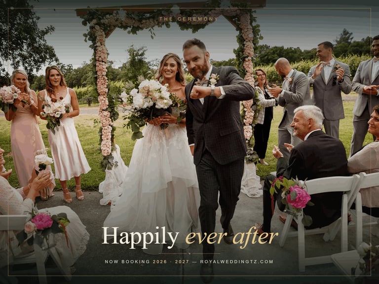 Bride and groom walking down outdoor aisle at wedding ceremony under floral arch Zanzibar destination wedding videography