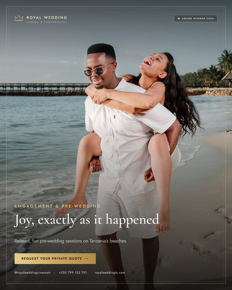 Man in white shirt carrying laughing woman on beach, both wearing sunglasses, with pier and palm trees in background