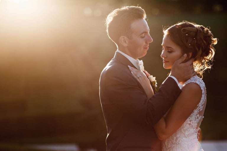 Bride and groom embracing at sunset on a Zanzibar beach, backlit with warm golden light during their Tanzania elopement photographer portrait session
