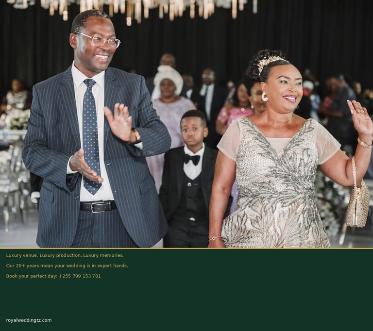 Man in gray pinstripe suit and woman in beige dress dancing at formal event with guests seated in background