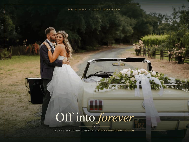 Newlyweds embracing beside a vintage convertible car decorated with white flowers and ribbons Zanzibar wedding getaway