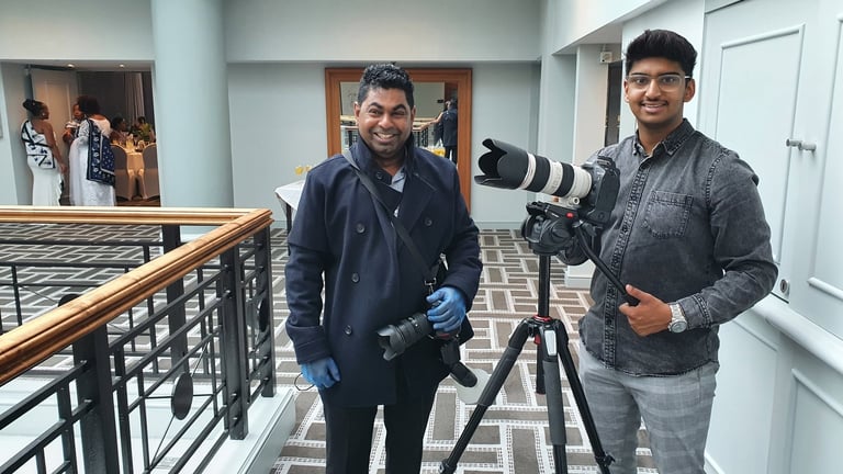 Royal Wedding Cinema team members in modern hallway with professional camera on tripod, Tanzania wedding photographers at work